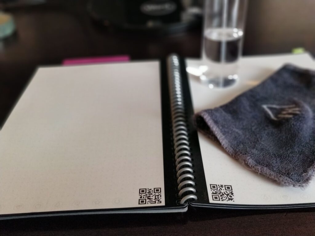 Rocketbook Fusion open with a clean page spread with cloth and spray bottle