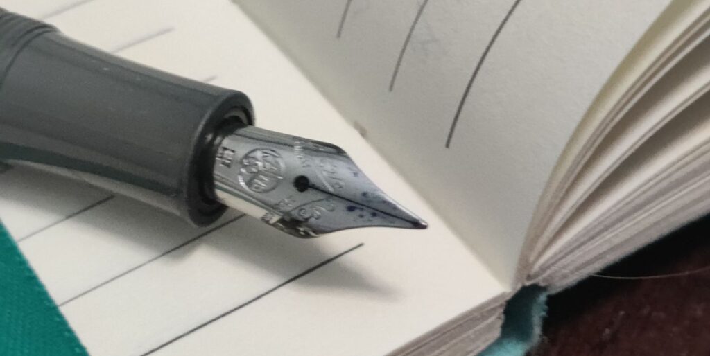 Kaweco Sport fountain pen with an extra fine nib in a ruled journal